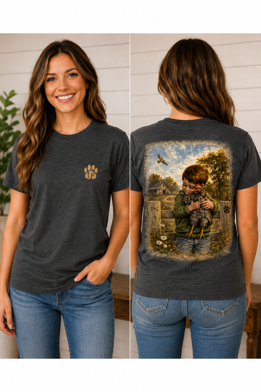 Woman wearing the A Boy and His Chicken graphic tee featuring a young boy walking with his favorite chicken on a country farm.