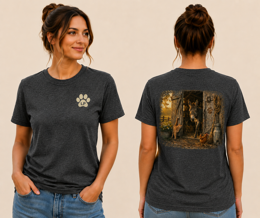 Woman wearing the Mornin' Roll Call graphic tee featuring a vintage farm scene with barnyard animals gathered for the morning.
